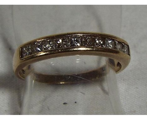 A lady's hallmarked 9 carat yellow gold half eternity ring size K, stone set with ten princess cut diamonds, approximate weig