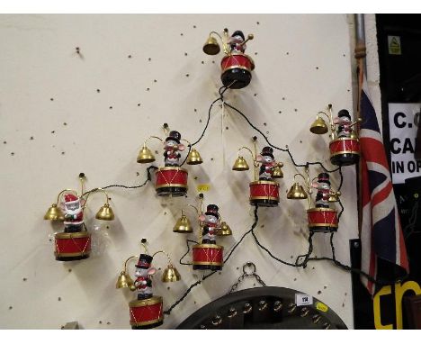 Santa's Marching Band, a string of eight musicians turning and striking 16 brass bells playing Christmas carols, boxed