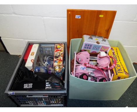 Two boxes containing a good mixed lot to include children's games, a pair of Hello Kitty roller skates, a quantity of cameras