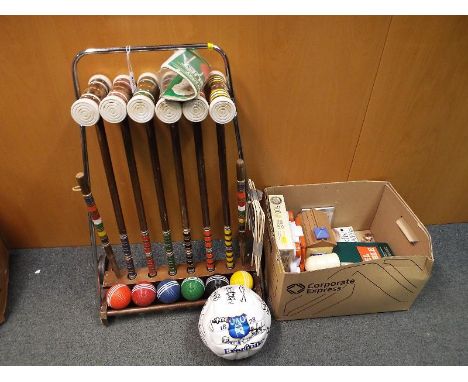 A wooden croquet set on a stand and a collection of children's toys to include Travel Scrabble, a set of cowboys and soldiers