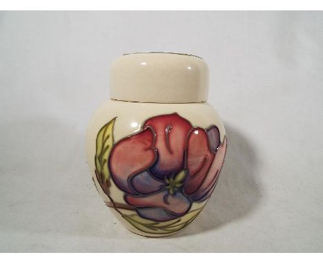 A Moorcroft Pottery covered ginger jar decorated with pink magnolia on a cream ground, 11 cm (high) - Est £50 - £80