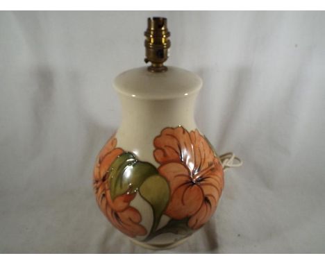 A Moorcroft Pottery large table lamp and shade, the base decorated with pink hibiscus on an ivorine ground, (the base 31 cm h