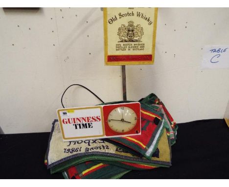 A Guinness Time advertising electric clock made by Westclox Ltd - included in the lot is a quantity of bar top drip mats and 