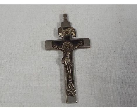 A vintage pendant depicting Skull and Crossbones at the foot of Christ on Pectoral Cross