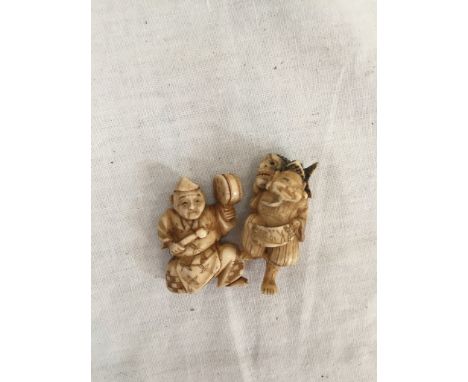 Two bone netsukes; man with fish, and drummer
