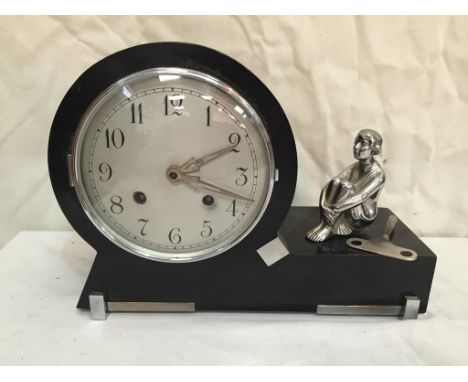 An ebonised Art Deco clock with a crow lady figure