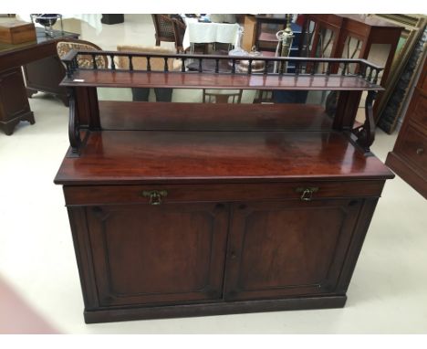 A 19th century mahogany mirrored back chiffoniere, the galleried shelf on scrolling supports, the base with a long fall front