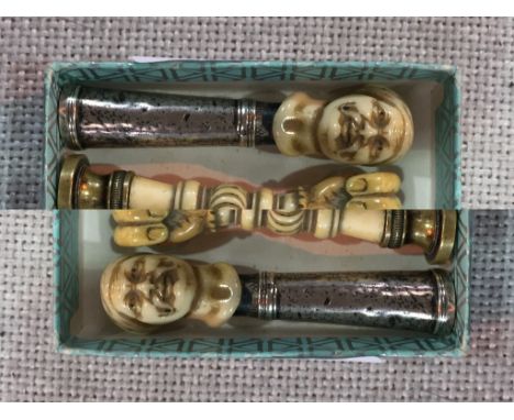 A mid-18th century silver and  carved ivory pipe tamper, stamped with maker's mark only E(?),  circa 1750,  the finial modell