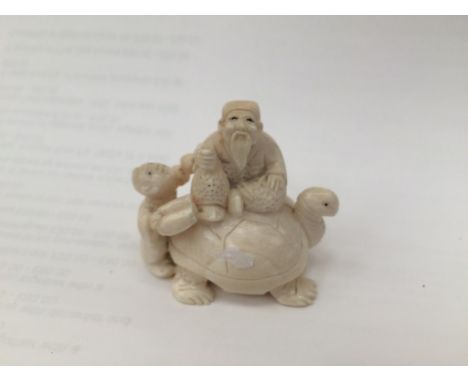 A Meiji period netsuke of a tortoise and men