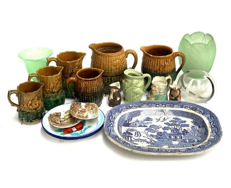 A mixed lot of glazed jugs; toby jugs; enamel poppy dishes; Johnson bros pin dishes; Willow pattern blue and white meat plate