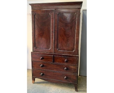 A Victorian mahogany linen press, with pediment top, two fielded panel doors opening to reveal slides, over a base of two sho