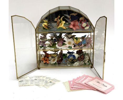 A collection of Franklin Mint butterflies of the world ceramic miniatures, in display case with original receipts 