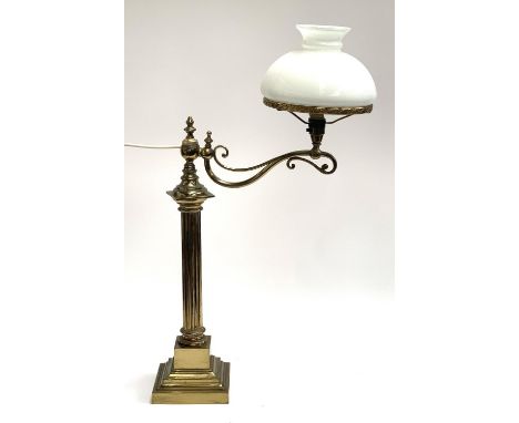 A gilt brass oil lamp, converted for use electrical use, with reeded column and adjustable arm, on square stepped base, with 