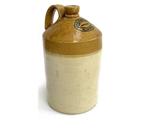 A large stoneware flagon with loop handle, marked 'John Lewis Marsh, Wine &amp; Spirit Merchant, Town Brewery Blandford', 41c