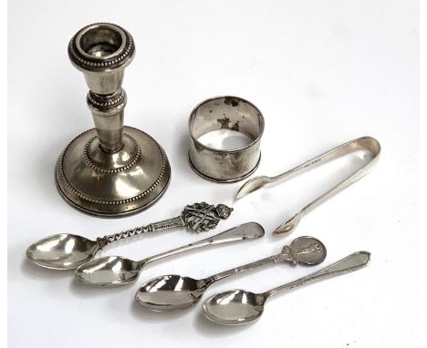 A small loaded silver candlestick by W I Broadway & Co, Birmingham; together with four silver spoons, a pair of sugar tongs, 