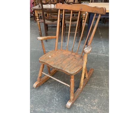 A 20th century pine comb back rocking chair 