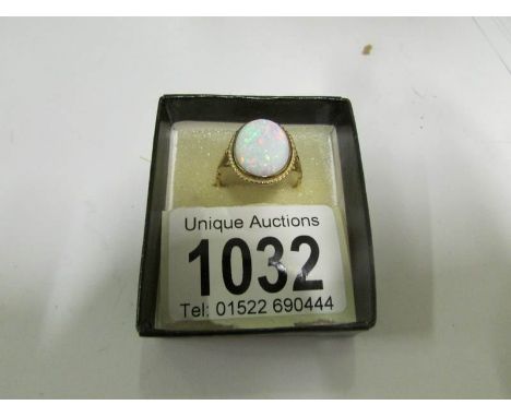 A 9ct gold ring set large oval opal