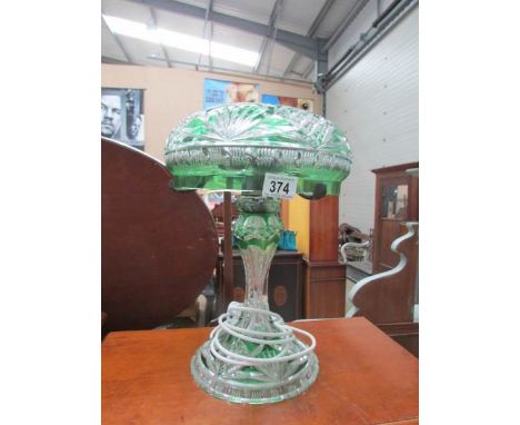 A cut glass table lamp with overlaid green decoration