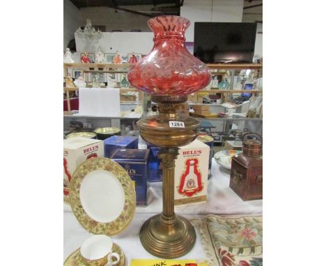 A brass Corinthian column oil lamp with glass font and mushroom shade