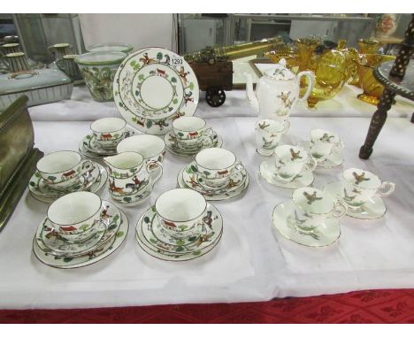 A 10 piece Crown Staffordshire coffee set decorated with duck & fen birds and a 21 piece tea set with fox hunting scenes