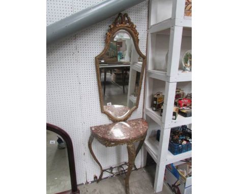 A brass console table with mirror