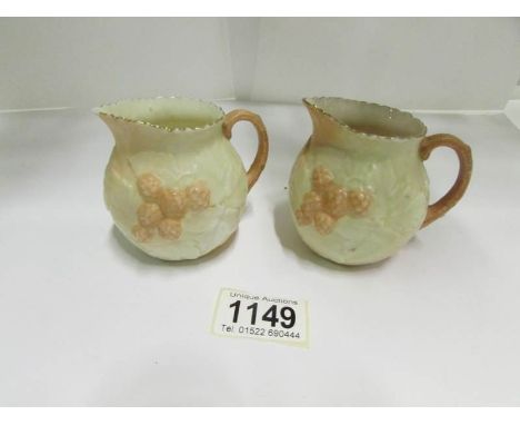A pair of Royal Worcester strawberry jugs