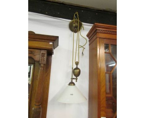 A brass French style rise and fall ceiling light