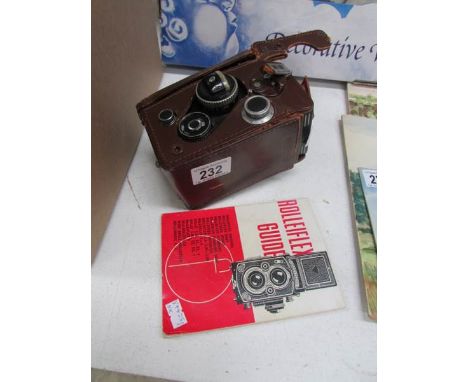 A Rolleiflex camera with case (a/f) and a Rolleiflex guide book