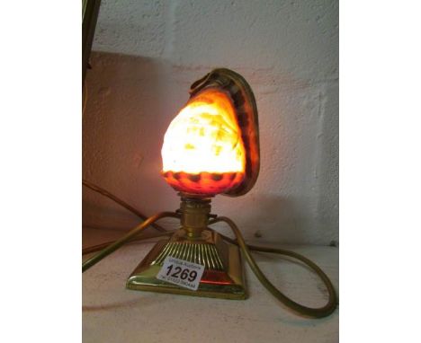 A carved cameo shell table lamp on brass base