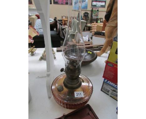 A Victorian glass oil lamp with chimney