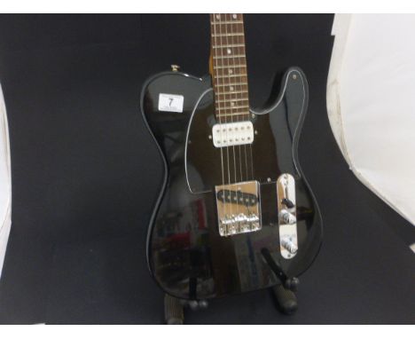 A black Telecaster style guitar with applied Fender decals (copy)