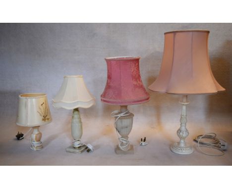 A miscellaneous collection of mid century table lamps with their shades to include marble and carved and painted examples. H.