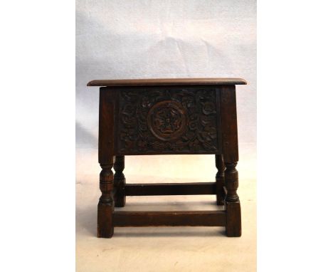 An 18th century country oak bible box stool with carved panel on turned tapering supports. H.47 W.44 D.24cm 