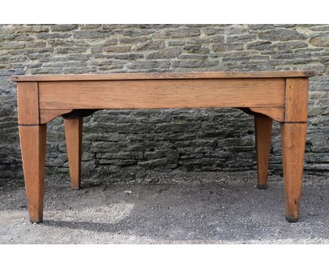 A mid century light oak library table with inset leather top and frieze drawer raised on square tapering supports. H.76 W.150