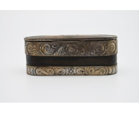 A engraved white metal and leather tin lined snuff box. An engraved shield shape cartouche and scrolling foliate designs to t