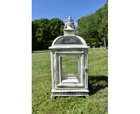 A distressed painted metal framed storm lantern, domed top and turned finial. H.60 W.24 D.24cm 