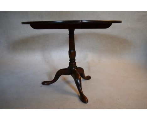 A Georgian mahogany tilt top table with baluster turned pedestal on tripod cabriole pad foot supports. H.71 Dia.94cm 