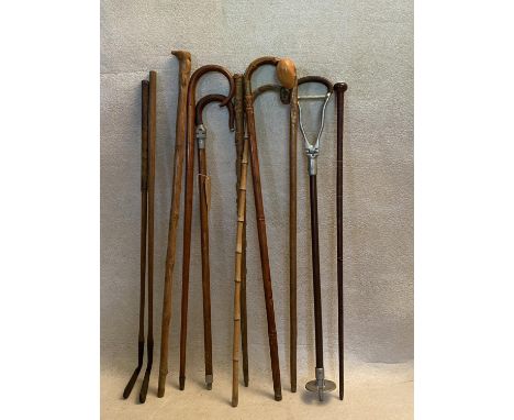 A miscellaneous collection of nine vintage sticks and two old golf clubs, to include a horse measuring walking stick and two 