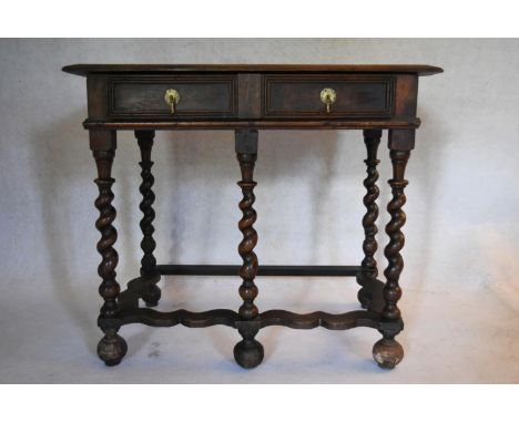 A late 17th century elm and oak side table with frieze drawers on barleytwist stretchered supports resting on bun feet. H.73 