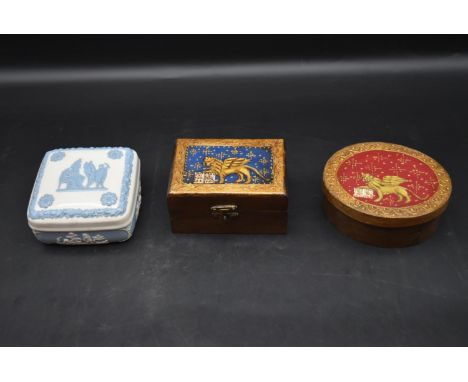 A Wedgwood blue and white lidded dressing table box along with two painted lidded boxes. H.6 W.11cm 