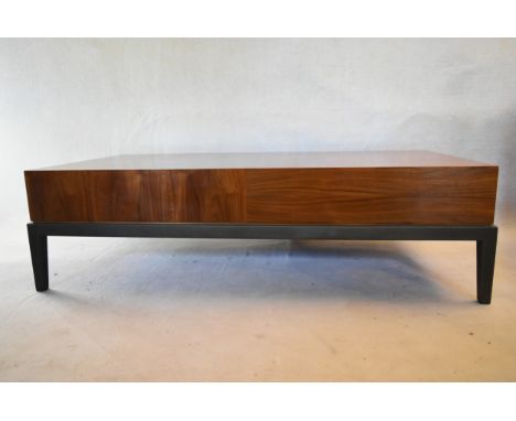 A contemporary teak coffee table fitted with end drawer on painted base with square tapering supports. H.46 W.168 D.56cm 