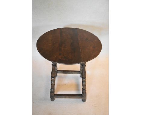 A 18th century country oak side table on turned stretchered supports. H.70 W.60 D.62cm 