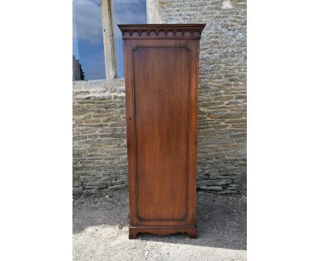 A Georgian style mahogany single wardrobe with panel door enclosing hanging section on shaped bracket feet. H.189 W.70 D.58cm