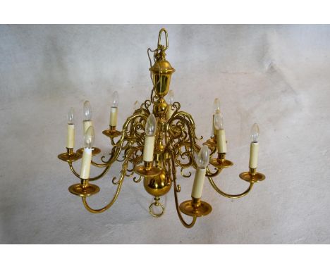 A large Dutch style brass chandelier with twelve scrolling branches in two tiers. H.81 W.85cm 