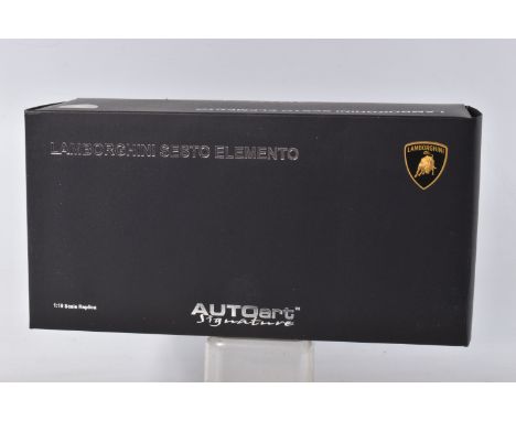 A BOXED AUTOART MODELS LAMBORGHINI SESTO ELEMENTO MODEL VEHICLE SCALE 1:18, numbered 74671, painted black with a carbon fibre