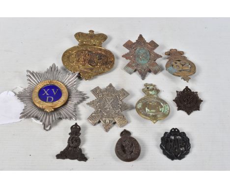 A SELECTION OF CAP BADGES AND SHAKO PLATES, this lot includes a 19th century British officers Shako plate with a blue enamel 