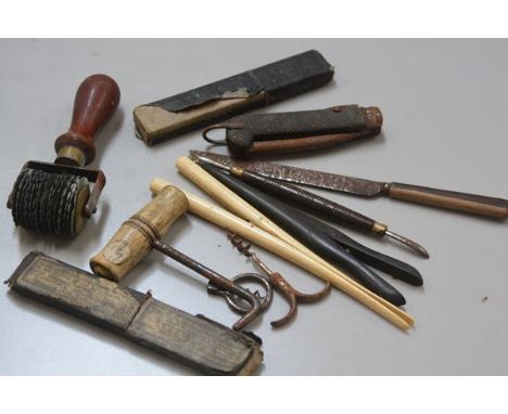 A collection of miscellaneous tools including a scribing tool, a folding corkscrew, a corkscrew, 19thc. ebony and ivory glove