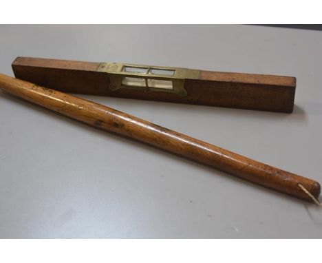 An E Preston &amp; Sons, treen brass mounted spirit level (h. 5cm x l. 46cm) and a Bosun's stick (l.56cm) (2)