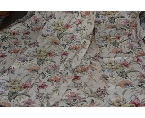 A pair of 1920s/30s printed linen mix curtains with lily and petunia design, cream ground (each curtain 274cm x 108cm)