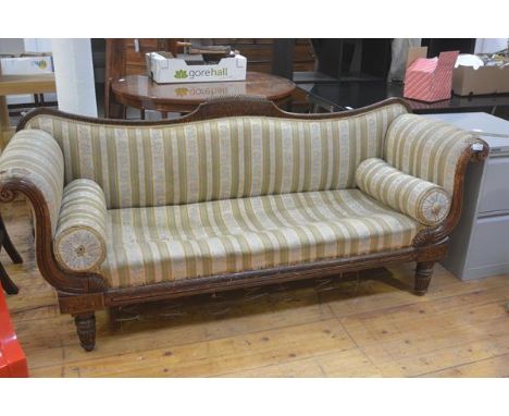 A William IV walnut Regency style scroll end drawing room sofa with inlaid panel back and fluted scroll arms, on fluted taper